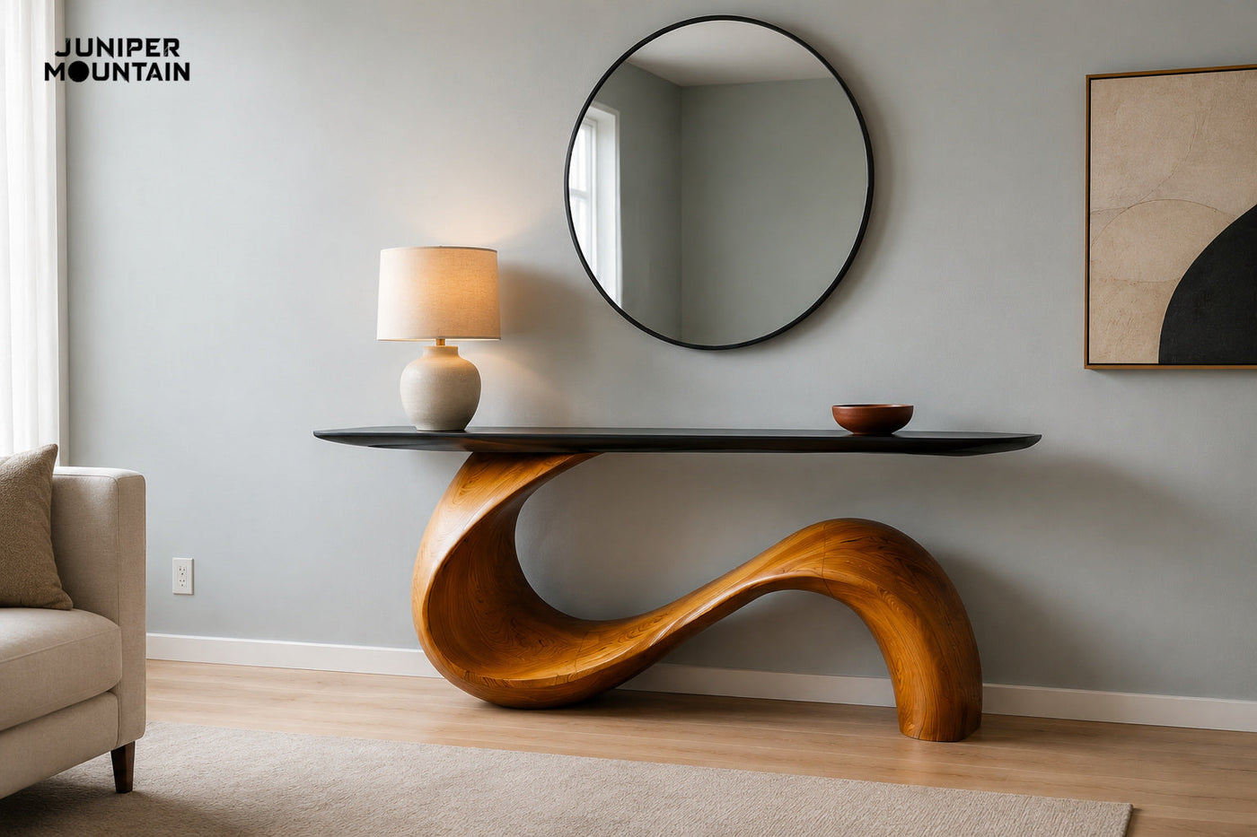 Black-top console with an amber-brown S-shaped base against a blue-gray wall